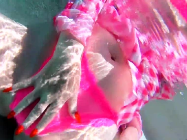 Redhead babe pleasures herself and gives oral in an outdoor pool