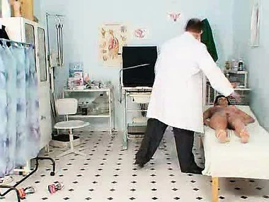 Valentina Rush, a mature brunette, undergoes a thorough gynecological examination while showcasing her large breasts