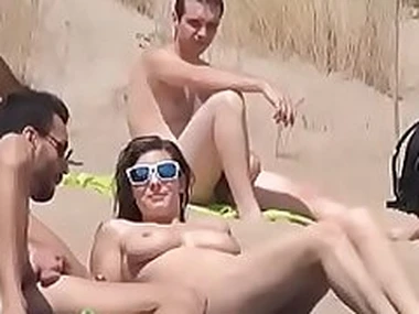 Sol fucks a guy in a beach surrounded by voyeurs